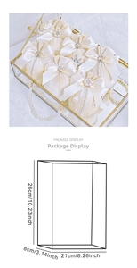 Detailed package display of velvet gift bags with pearls in a gold metal glass display box
