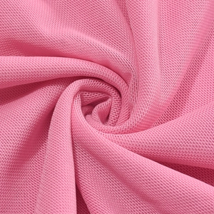 Close-up of pink breathable mesh fabric showing detailed texture and high flexibility