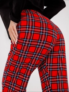 Detailed view of red and black tartan plaid pajama pants with comfortable elastic waistband