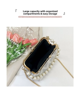 Detail of herringbone pattern shell bag with pearl handle and golden chain link