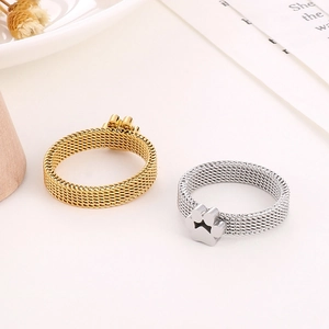 Detail of mesh stainless steel rings in gold and silver with star cat paw cutout