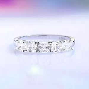 Macro shot of S925 silver ring featuring five square-cut cubic zirconia in a row