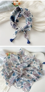 Detail of floral printed cotton linen scarf featuring dark blue tassels and boho pattern