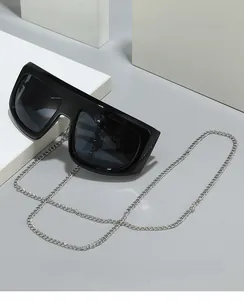 Detail of black Y2K oversized sunglasses with detachable silver metal neck chain