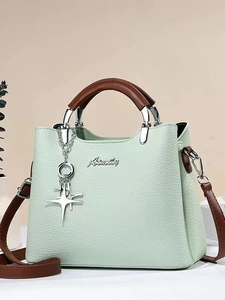 Mint green bucket bag with brown handles and star charm, versatile women's shoulder bag