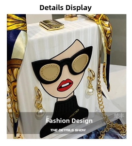 Detail of white box clutch with pop art graphic, gold hardware and silk scarf wrap