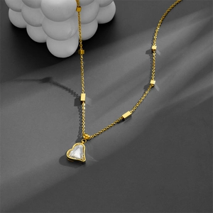 Elegant gold heart pendant necklace with small square beads on a minimalist chain