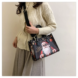 Black Christmas tote bag featuring Santa Claus print and wide shoulder strap detail