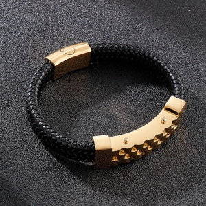 Detailed view of black braided leather bracelet with polished gold magnetic clasp