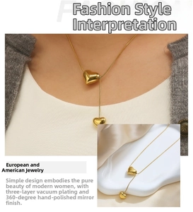 Detailed macro view of gold heart pendants on a slim snake chain with mirror polish