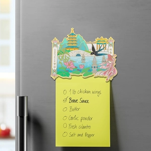 Detail of metal Hangzhou West Lake souvenir magnet featuring Leifeng Pagoda on fridge
