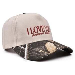 Detailed close-up of retro baseball cap with cherry embroidery and camouflage visor