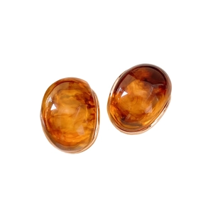 Elegant amber resin oval stud earrings with vintage polished finish on white background
