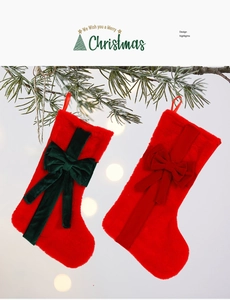 Detail of plush red Christmas stockings with large velvet bows hanging on pine branches