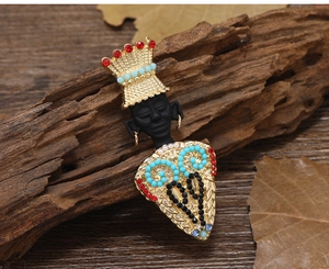 Detailed close-up of exotic retro tribal chief brooch with colorful beads and tassels