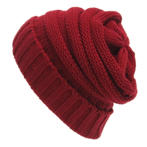 Detailed texture of dark red knit beanie showing soft acrylic yarn and ribbed cuff
