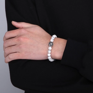 White marble bead bracelet with black gothic skull cross pendant worn on a male wrist