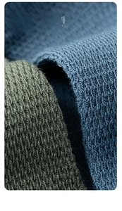 Macro shot of breathable combed cotton fabric texture in navy blue and olive green