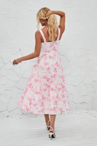 Detail view of the back of a pink floral midi sundress with delicate double straps