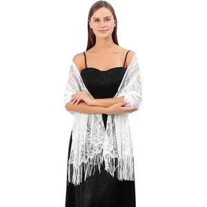 Close-up of white lace shawl featuring floral hollow patterns and delicate long tassels