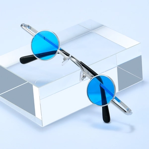 Retro small round punk sunglasses with silver metal frame and bright blue lenses