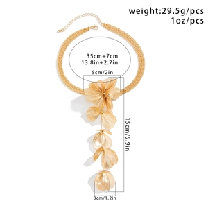Detail of golden choker featuring layered chains and five brushed metal flower charms
