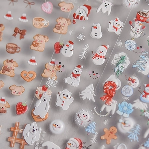 Detail of 3D embossed nail art stickers featuring winter bears and coffee shop patterns