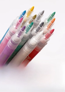 Detailed view of colorful acrylic nail art markers with fine tips for DIY manicure designs