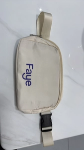 Macro detail of beige nylon running bag showing the purple Faye text and black buckle clasp