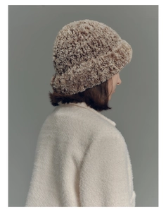 Detail view of the fuzzy faux fur bucket hat with a textured gradient brown plush finish