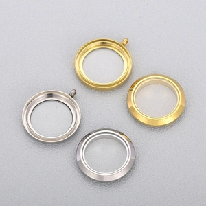 Detailed view of circular stainless steel locket pendants in gold and silver finishes