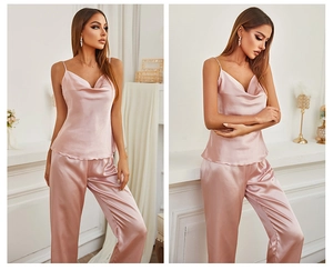Detail of elegant dusty pink satin pajamas set with V-neck camisole and loose pants