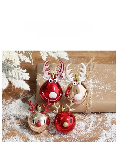 Close-up of reindeer themed Christmas baubles in red and gold with 3D antlers