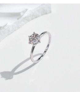 Detailed view of 1 carat moissanite silver ring with classic six-prong setting detail