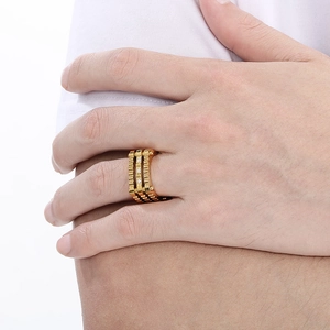 Detailed view of punk gear link ring in gold finish with three vertical crystal stones