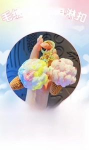 Detail of crochet ice cream keychain featuring handmade knit cones and pink plush swirls