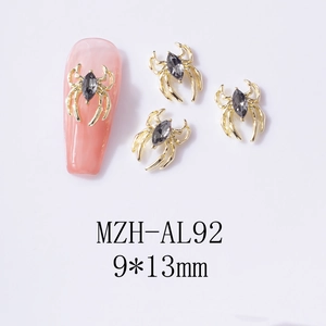 Macro detail of a 9x13mm gold spider nail art charm with a black marquise rhinestone