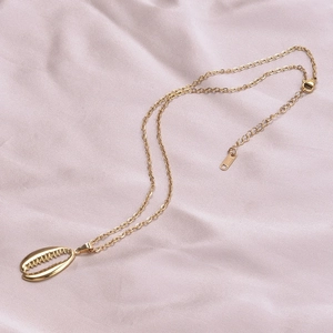 Close-up of a 18k gold plated stainless steel necklace featuring a shell pendant