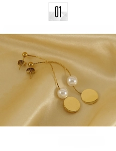 Detailed macro of 18K gold tassels on titanium earrings with elegant pearl accents