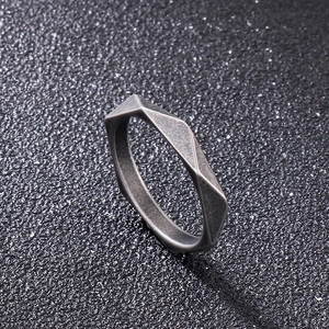 Macro shot of geometric faceted stainless steel ring with antique silver finish detail
