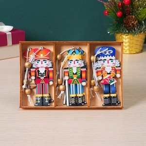 Three hand-painted wooden nutcracker ornaments in a wooden box with Christmas decor