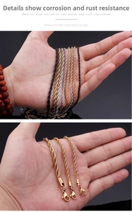 Detailed view of rope chain necklace featuring a lobster clasp in black, silver, and gold