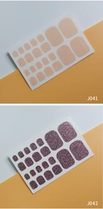 Detail view of J041 nude and J042 magenta glitter toe nail wraps with shimmering finish