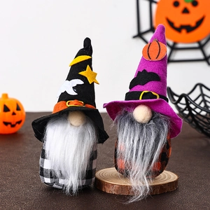 Close-up of Halloween plush gnomes with orange and black plaid on a wooden base with pumpkins