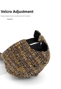 Macro detail of the tweed baseball cap featuring an adjustable velcro strap at the back
