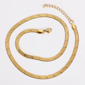Detailed view of gold flat snake chain necklace with lobster clasp and extension