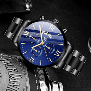 Detail of navy blue dial with golden Roman numerals and calendar display on steel watch