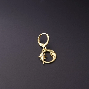 Detail of a celestial gold ear cuff featuring a crescent moon face and a zircon star charm