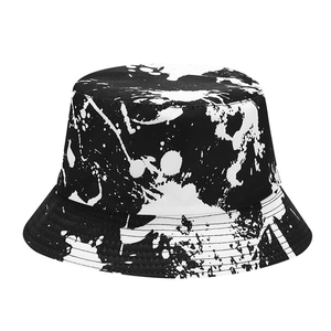 Graffiti style reversible bucket hat with black and white ink splash pattern for sun protection