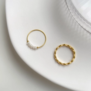 Minimalist French style gold rings set with elegant pearls and geometric patterns
